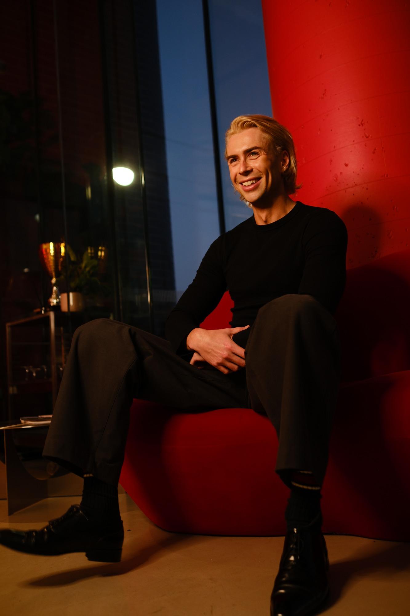 Kurt Coleman seated on a red chair, smiling